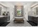 Luxurious bathroom showcasing a soaking tub beneath a chandelier, dual vanities, and patterned tile flooring at 6031 Dora Dr, Mount Dora, FL 32757