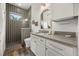 Bathroom featuring a walk-in shower with mosaic tile, gray countertop, and modern vanity at 6031 Dora Dr, Mount Dora, FL 32757