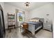 Comfortable bedroom with a queen bed, bedside tables, wood floors, and a sunny window, a serene retreat at 6031 Dora Dr, Mount Dora, FL 32757