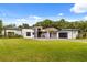 Stunning modern home with expansive lawn and driveway, lush landscaping, and attached garage at 6031 Dora Dr, Mount Dora, FL 32757