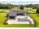 A beautiful backyard with a modern pool, spa, and ample lounge area offers a perfect outdoor oasis at 6031 Dora Dr, Mount Dora, FL 32757