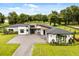 Charming exterior showcasing modern design elements, lush landscaping, and a welcoming entrance to a great home at 6031 Dora Dr, Mount Dora, FL 32757