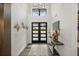Bright foyer featuring a modern chandelier, console table with decor, and a patterned rug at 6031 Dora Dr, Mount Dora, FL 32757