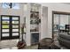 Foyer view with wine fridge, bar, modern seating, large windows, and door to the outside at 6031 Dora Dr, Mount Dora, FL 32757