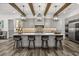 Elegant kitchen with a large center island, pendant lighting, stainless steel appliances, and stylish backsplash at 6031 Dora Dr, Mount Dora, FL 32757