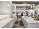 Gorgeous kitchen featuring stainless steel appliances, gray cabinets, and a large island with white countertop at 6031 Dora Dr, Mount Dora, FL 32757