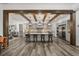 Spacious kitchen featuring a large center island, gray cabinetry, stainless steel appliances, and beautiful light fixtures at 6031 Dora Dr, Mount Dora, FL 32757