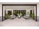 Covered patio features outdoor sofas and views of backyard pool and mature landscaping at 6031 Dora Dr, Mount Dora, FL 32757