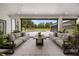 Covered patio with outdoor sofas offers backyard view of pool and landscaping at 6031 Dora Dr, Mount Dora, FL 32757