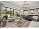 Spacious living room with floor-to-ceiling windows, a chandelier, and an open-concept design at 6031 Dora Dr, Mount Dora, FL 32757