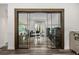 Stylish office with glass doors, modern desk, shelving, and wood-look floors at 6031 Dora Dr, Mount Dora, FL 32757