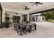 Elegant outdoor dining area with spacious seating and ceiling fans, perfect for al fresco meals and relaxation at 6031 Dora Dr, Mount Dora, FL 32757