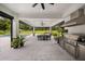 Enjoy seamless indoor-outdoor living with an outdoor kitchen, dining, and pool views at 6031 Dora Dr, Mount Dora, FL 32757