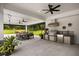 Outdoor kitchen and dining area featuring stainless steel appliances and a stone counter top for entertaining at 6031 Dora Dr, Mount Dora, FL 32757