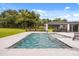 In-ground pool with in-pool fountains and modern lanai overlooks a backyard with mature trees at 6031 Dora Dr, Mount Dora, FL 32757