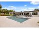 Spacious lanai and in-ground pool with in-pool fountains, set against a backdrop of lush greenery at 6031 Dora Dr, Mount Dora, FL 32757