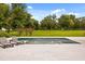 Inviting pool with spa, in-pool fountains, and lounge chairs overlooks a spacious backyard at 6031 Dora Dr, Mount Dora, FL 32757