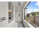 Modern shower featuring a glass partition, large window, and designer tile, blending style with natural light at 6031 Dora Dr, Mount Dora, FL 32757