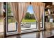 Window view of a backyard with a pool and lounge chairs and custom window trims and shelves at 6031 Dora Dr, Mount Dora, FL 32757