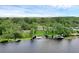 Aerial view of waterfront property with a private dock and lush green lawn, enclosed by a white border at 6136 Lake Emma Rd, Groveland, FL 34736