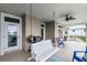 View of a covered back porch with a porch swing and view of the water in the background at 6136 Lake Emma Rd, Groveland, FL 34736