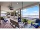 View of the lake from a covered porch featuring a porch swing and outdoor furniture at 6136 Lake Emma Rd, Groveland, FL 34736