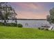 A serene view of the waterfront from the lush green backyard of the property at 6136 Lake Emma Rd, Groveland, FL 34736
