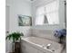 Bright bathroom with a garden tub, tile accents, and stylish decor at 6136 Lake Emma Rd, Groveland, FL 34736