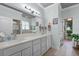 Bathroom features double sinks, updated fixtures, and quartz countertops at 6136 Lake Emma Rd, Groveland, FL 34736