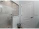 Modern shower with tiled walls and glass enclosure next to a white door at 6136 Lake Emma Rd, Groveland, FL 34736