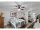 Comfortable bedroom with ceiling fan, hardwood floors, mirrored closets, and wood furniture at 6136 Lake Emma Rd, Groveland, FL 34736