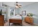 Cozy bedroom with natural light, wooden furniture, ceiling fan and light blue walls at 6136 Lake Emma Rd, Groveland, FL 34736