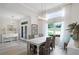 Bright dining room featuring a large window and elegant chandelier lighting at 6136 Lake Emma Rd, Groveland, FL 34736