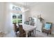 Bright dining room featuring a large window and elegant chandelier lighting at 6136 Lake Emma Rd, Groveland, FL 34736