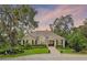 Charming single-story home featuring a well-manicured front yard and inviting entryway at 6136 Lake Emma Rd, Groveland, FL 34736