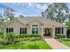 Charming single-story home featuring a well-manicured front yard and inviting entryway at 6136 Lake Emma Rd, Groveland, FL 34736