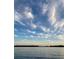 Beautiful lake view with a serene, reflective surface under a partly cloudy blue sky at dusk at 6136 Lake Emma Rd, Groveland, FL 34736