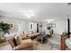 Comfortable living room with light hardwood floors, ceiling fan, neutral walls, and casual decor at 6136 Lake Emma Rd, Groveland, FL 34736