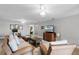 The living room features neutral colored walls, hard wood flooring, ceiling fans, and comfortable decor at 6136 Lake Emma Rd, Groveland, FL 34736