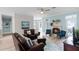 Inviting living room boasts a fireplace, plush seating, and serene waterfront views at 6136 Lake Emma Rd, Groveland, FL 34736