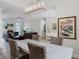 Open-concept living space with dining area, fireplace, and hardwood floors at 6136 Lake Emma Rd, Groveland, FL 34736