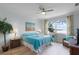 Cozy main bedroom featuring a ceiling fan, water view and stylish decor at 6136 Lake Emma Rd, Groveland, FL 34736