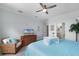 Comfortable main bedroom with a lake view, wicker chair and a calming design at 6136 Lake Emma Rd, Groveland, FL 34736