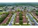 Expansive aerial view of the community with beige condos, tile roofs, lush trees, and manicured lawns at 624 Terra Lago St, Davenport, FL 33897