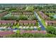 Aerial view of tan condominiums with tile roofs and mature landscaping in a vibrant community at 624 Terra Lago St, Davenport, FL 33897