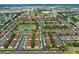 Aerial view of a well-maintained community with lush greenery, a pond, and orderly townhome rows at 624 Terra Lago St, Davenport, FL 33897