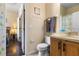 Bright bathroom with wooden vanity, single sink, and open doorway to bedroom at 624 Terra Lago St, Davenport, FL 33897