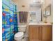 Bright bathroom features a colorful shower curtain and vanity at 624 Terra Lago St, Davenport, FL 33897