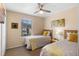 Bright bedroom with two twin beds, natural light, ceiling fan, and comfortable beds at 624 Terra Lago St, Davenport, FL 33897