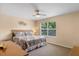 Comfortable bedroom with a ceiling fan and natural light from the window at 624 Terra Lago St, Davenport, FL 33897